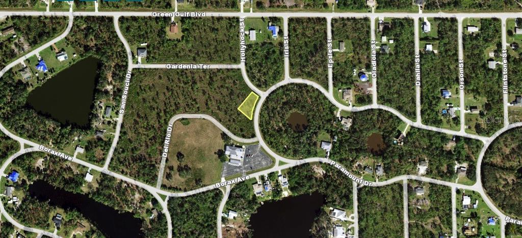 This is an aerial map showing a vacant lot highlighted in yellow within a residential neighborhood — 12069 HOLLYHOCK STREET, PUNTA GORDA, FL