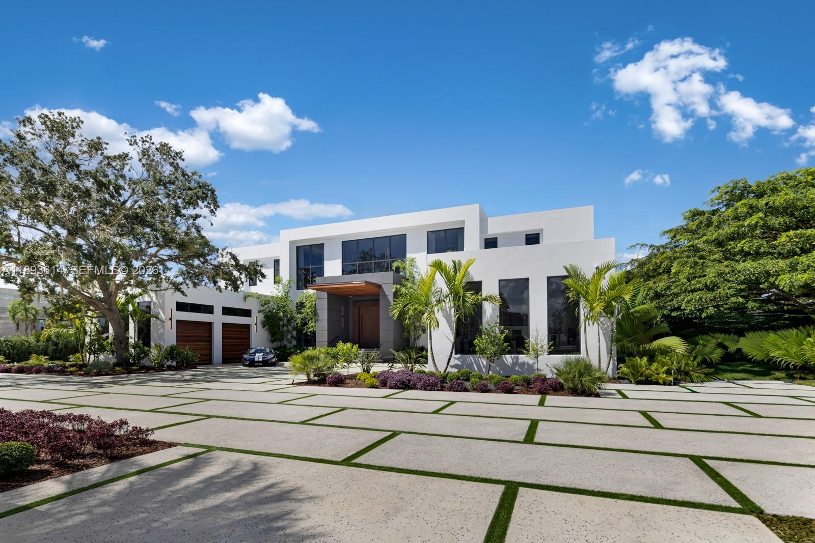 A modern two-story white house features a large concrete paver driveway and palm trees — 9900 SW 125th Ave, Miami FL 33186, MIAMI, FL