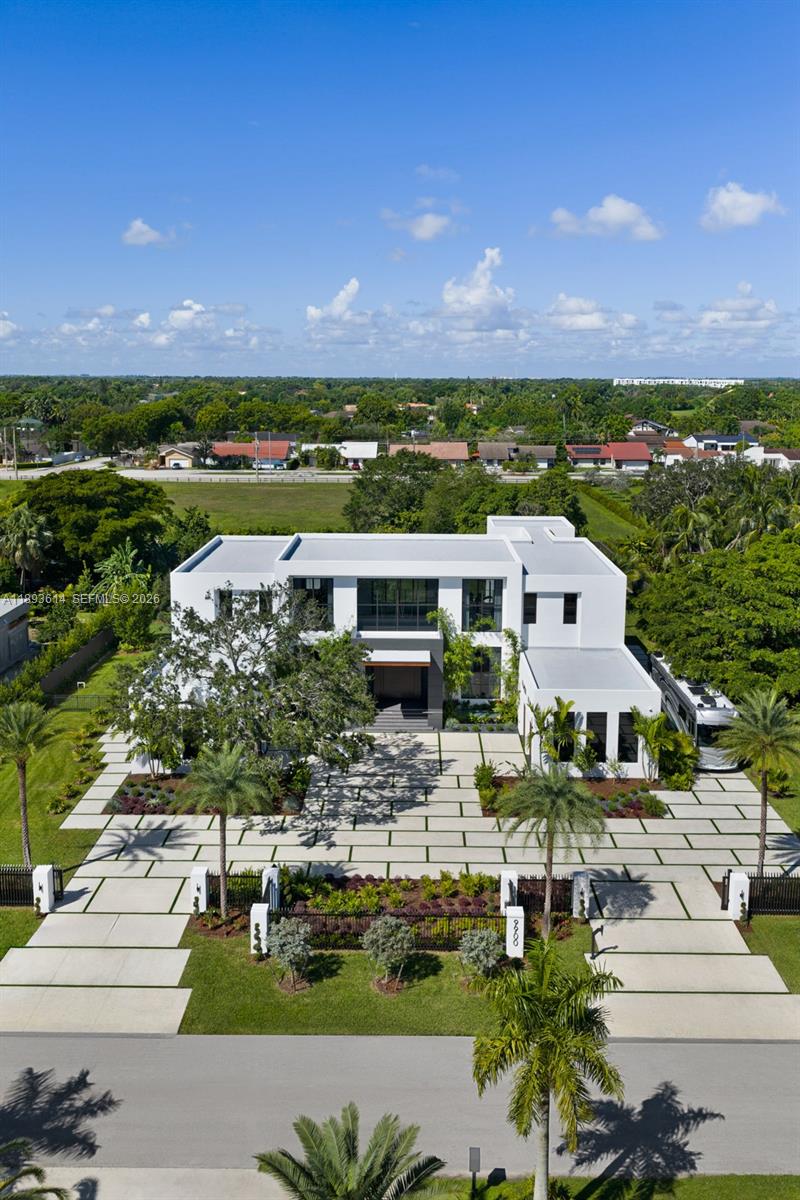 An aerial view of a modern white two-story house with a large paved driveway — 9900 SW 125th Ave, Miami FL 33186, MIAMI, FL