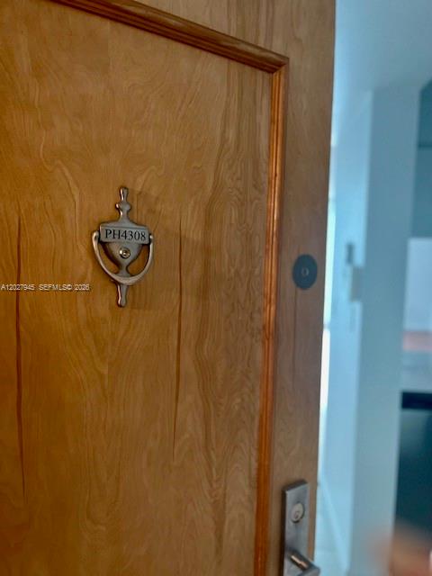 A wooden door features a silver door knocker with the unit number PH4308 — 1200 Brickell Bay Dr # 4308, Miami FL 33131, MIAMI, FL
