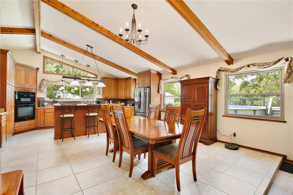 A kitchen with wood cabinets, granite countertops, stainless steel appliances, and a central island — 106 POLO LANE, SANFORD, FL