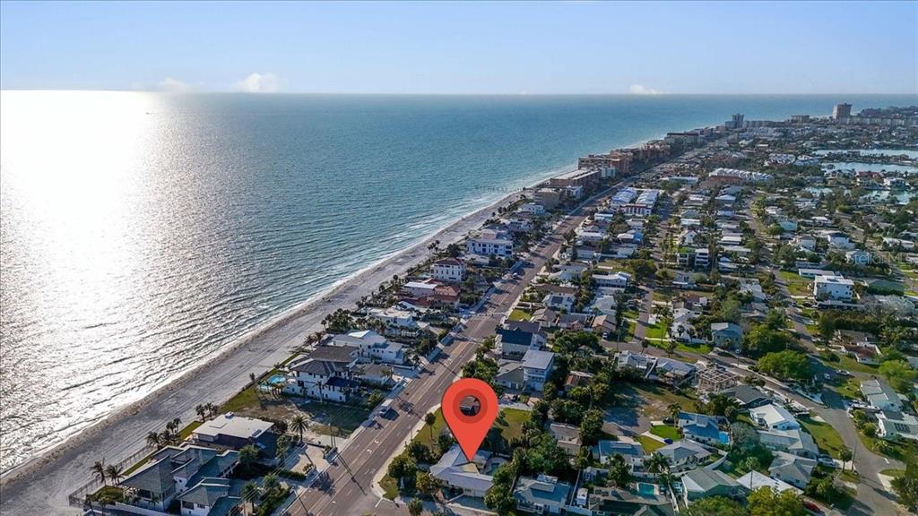 An aerial view shows a coastal neighborhood with a red location pin over a house — 16007 GULF BOULEVARD, REDINGTON BEACH, FL
