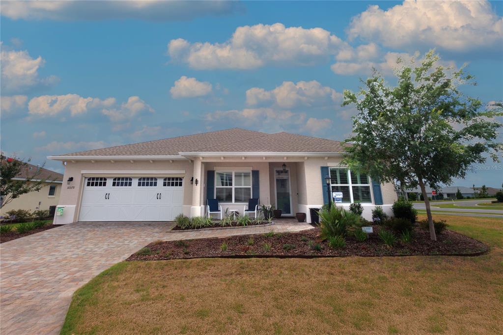 A single-story house with a two-car garage, a paved driveway, and a front porch — 10378 SW 96TH LOOP, OCALA, FL