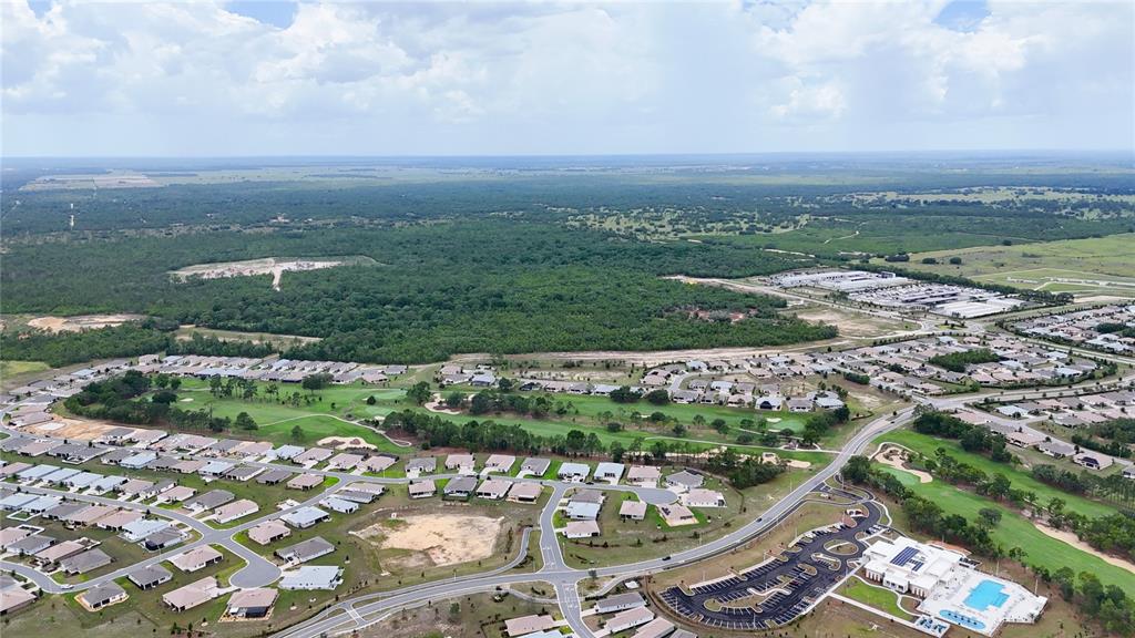 An aerial view shows a residential neighborhood with a golf course and a community clubhouse — 10378 SW 96TH LOOP, OCALA, FL