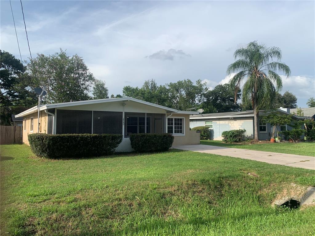 A single-story house with a screened-in front porch and a concrete driveway — 1915 WEEKS AVENUE, ORLANDO, FL