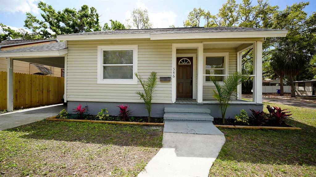 A single-story house with light siding, a front porch, and a carport — 546 16TH AVENUE S, ST PETERSBURG, FL