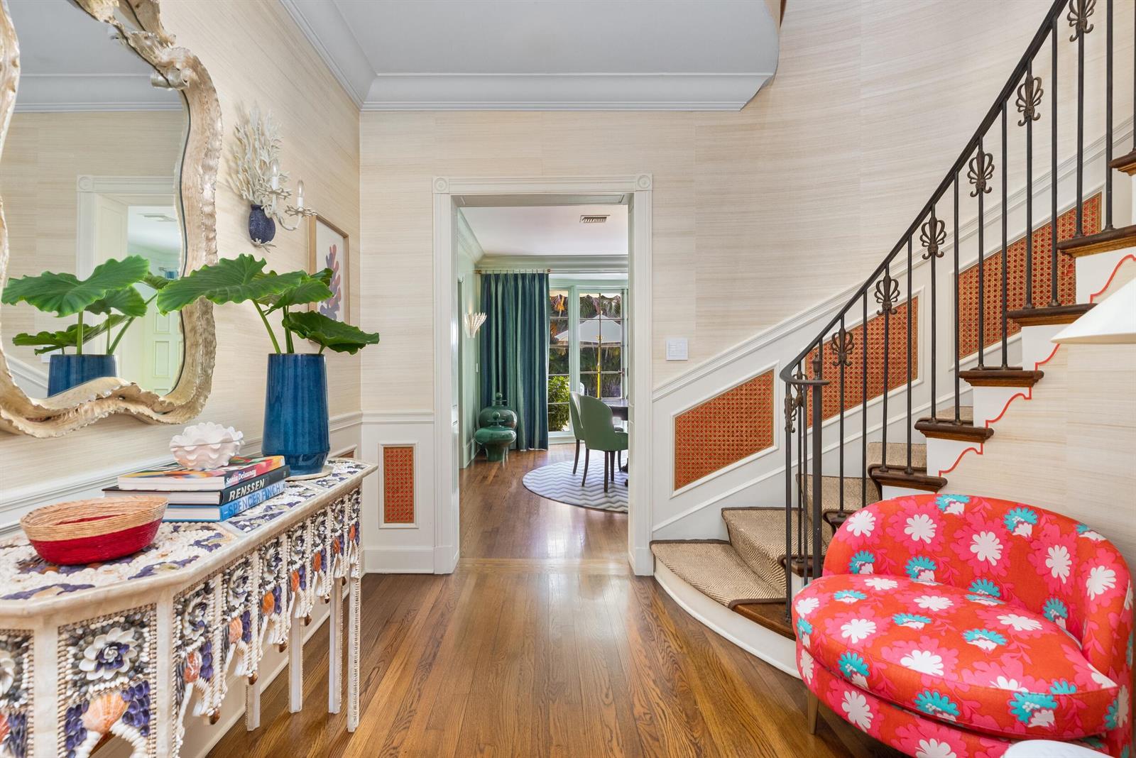 A foyer features a staircase with patterned panels, a shell-adorned console table, and floral seating — 246 Emerald Lane, Palm Beach FL 33480, PALM BEACH, FL