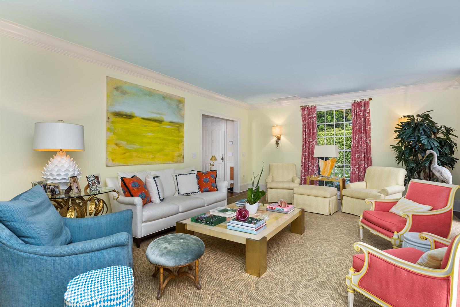 A living room features a white sofa, colorful armchairs, a coffee table, and yellow walls — 246 Emerald Lane, Palm Beach FL 33480, PALM BEACH, FL