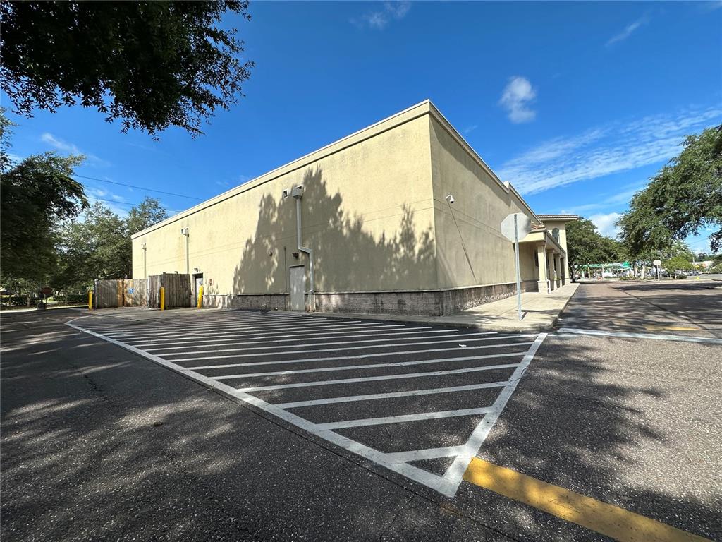 A beige commercial building exterior features a large parking lot with painted white safety stripes — 3917 N NEBRASKA AVENUE, TAMPA, FL