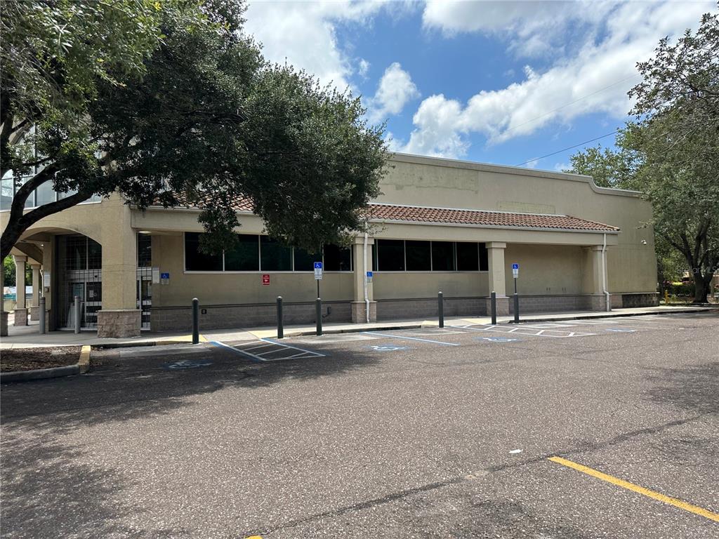 A beige commercial building exterior with a tiled roof and a paved parking lot — 3917 N NEBRASKA AVENUE, TAMPA, FL