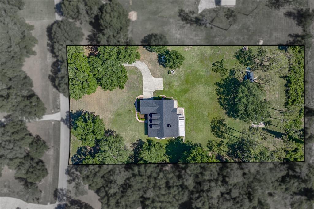 A gray, single-story house with a covered front porch and three dormer windows — 810 SAVANNAH OAKS DRIVE, BROOKSVILLE, FL