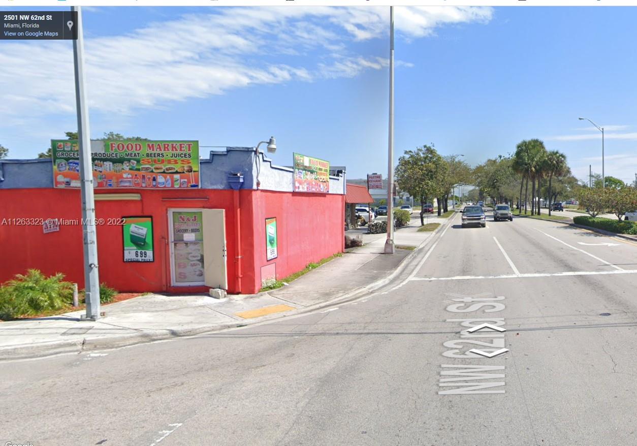 A red corner building with a food market sign stands at a street intersection — 2467 NW 62nd St, Miami FL 33147, MIAMI, FL
