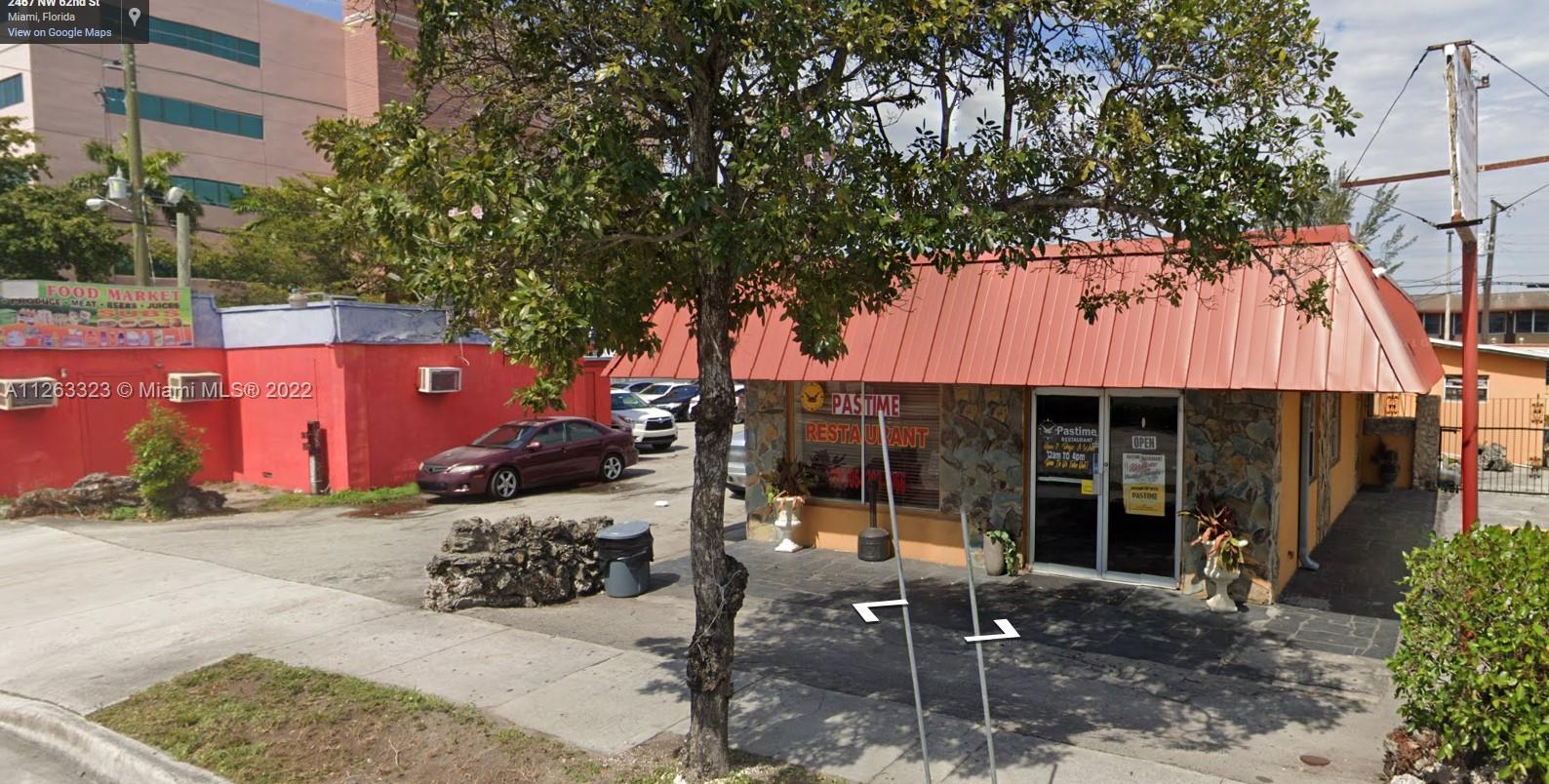 A single-story restaurant building with a red metal roof and stone facade exterior — 2467 NW 62nd St, Miami FL 33147, MIAMI, FL