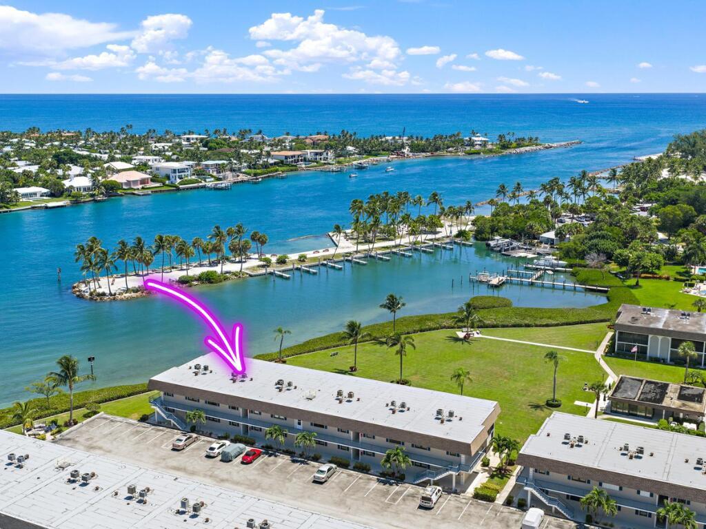 An aerial view of a multi-story apartment building located along a waterfront with boat docks — 755 Saturn D205 Street # D205, Jupiter FL 33477, JUPITER, FL