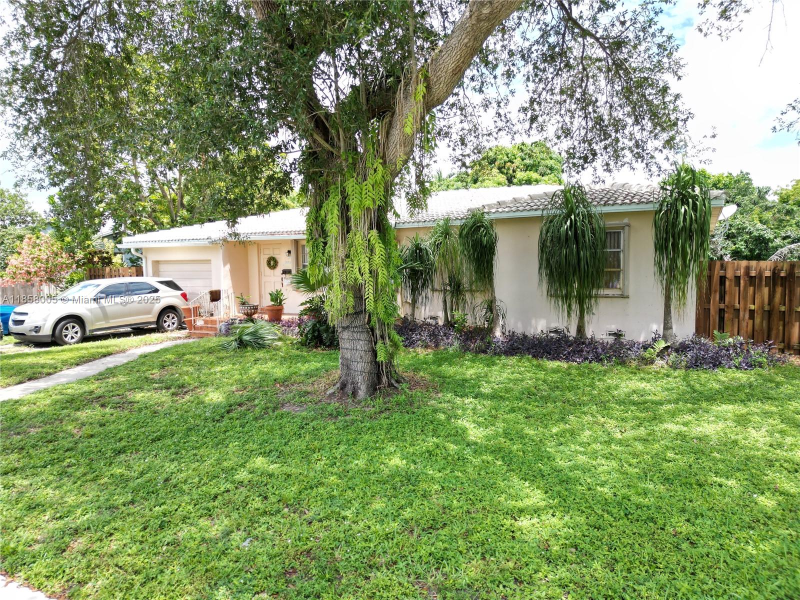A single-story house with a tile roof, a large tree, and a parked silver SUV — 2527 Fillmore St, Hollywood FL 33020, HOLLYWOOD, FL