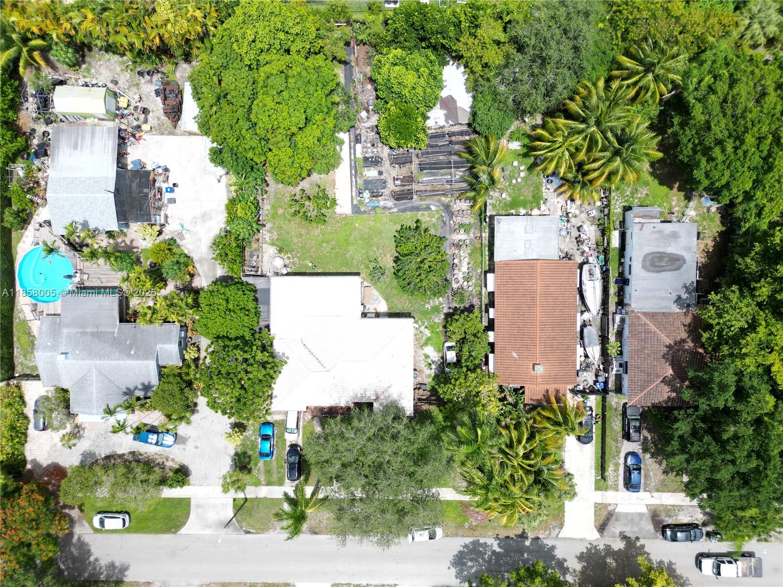 An aerial view shows three residential properties with driveways, swimming pools, and dense surrounding trees — 2527 Fillmore St, Hollywood FL 33020, HOLLYWOOD, FL