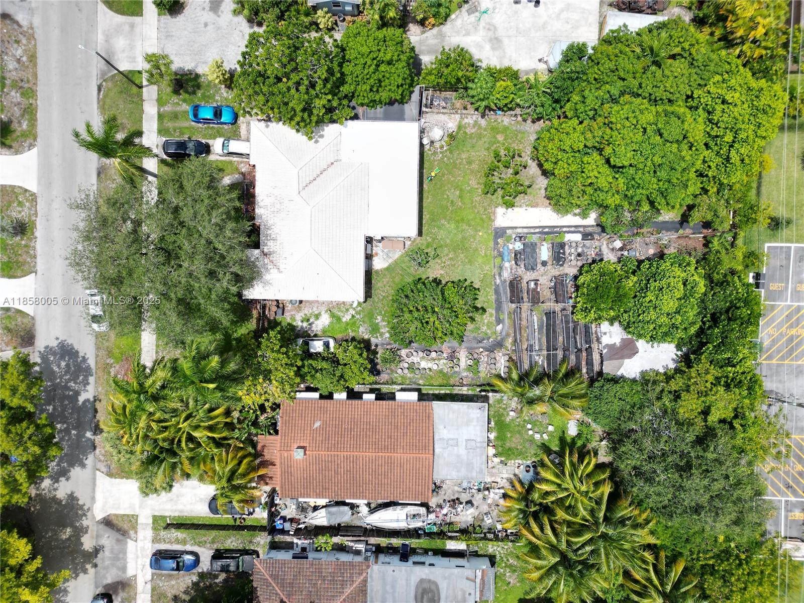 An aerial view shows two houses with yards, trees, and parked vehicles on a residential street — 2527 Fillmore St, Hollywood FL 33020, HOLLYWOOD, FL