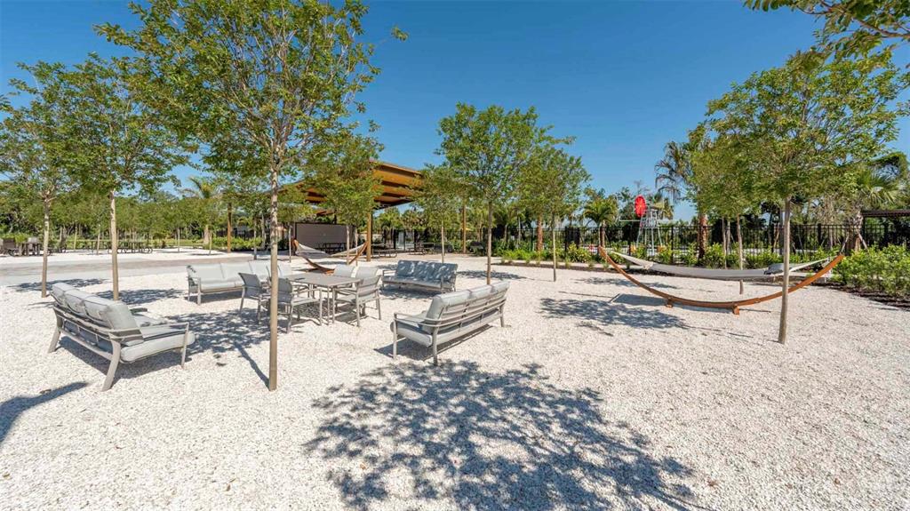 A modern kitchen features white cabinets, stainless steel appliances, and light-colored countertops — 13132 BENDING CREEK TRAIL, PALMETTO, FL