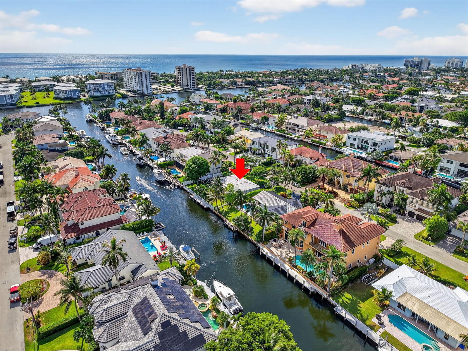An aerial view shows a waterfront house with a pool, marked by a red arrow — 937 Banyan Drive, Delray Beach FL 33483, DELRAY BEACH, FL