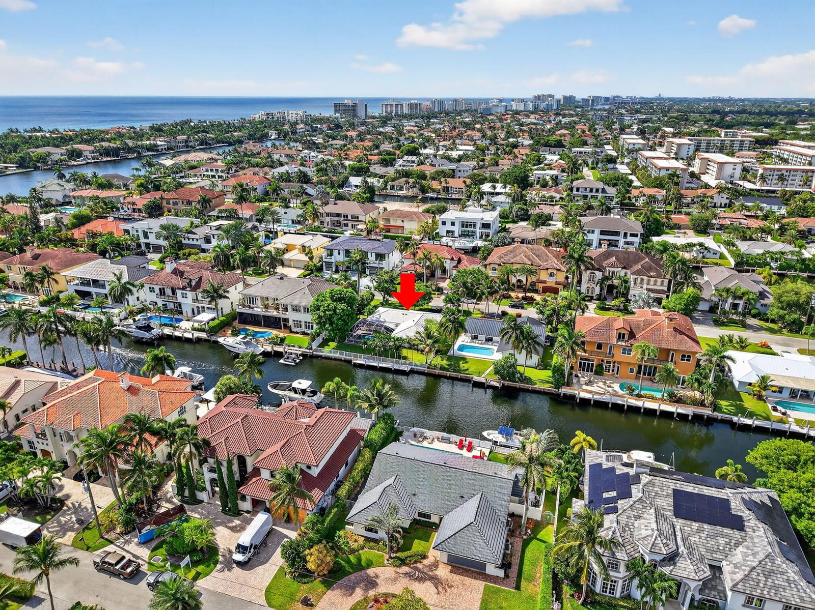 An aerial view shows a waterfront residential neighborhood with houses, swimming pools, and docked boats — 937 Banyan Drive, Delray Beach FL 33483, DELRAY BEACH, FL