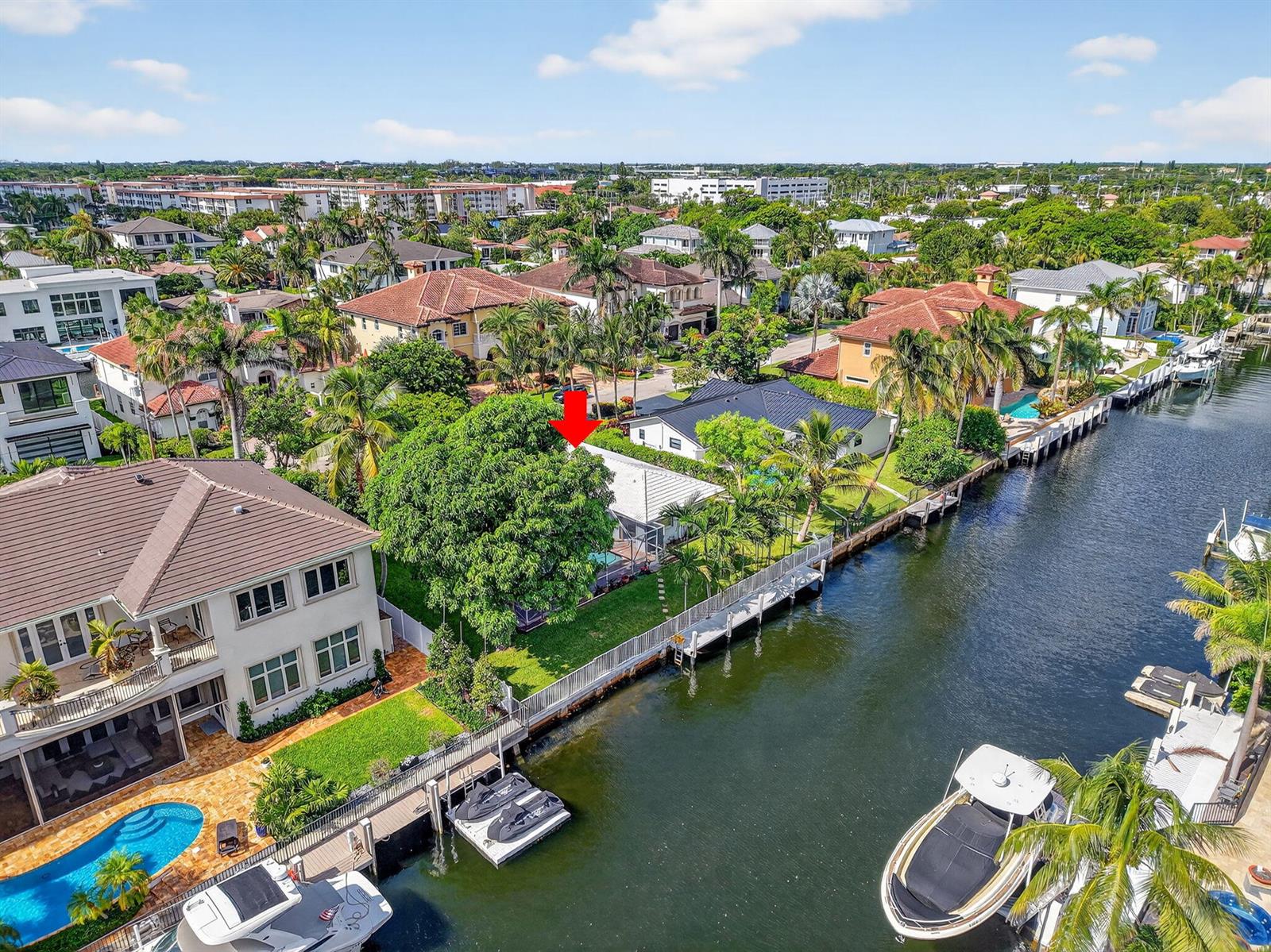 An aerial view shows a waterfront house with a pool and boat dock — 937 Banyan Drive, Delray Beach FL 33483, DELRAY BEACH, FL