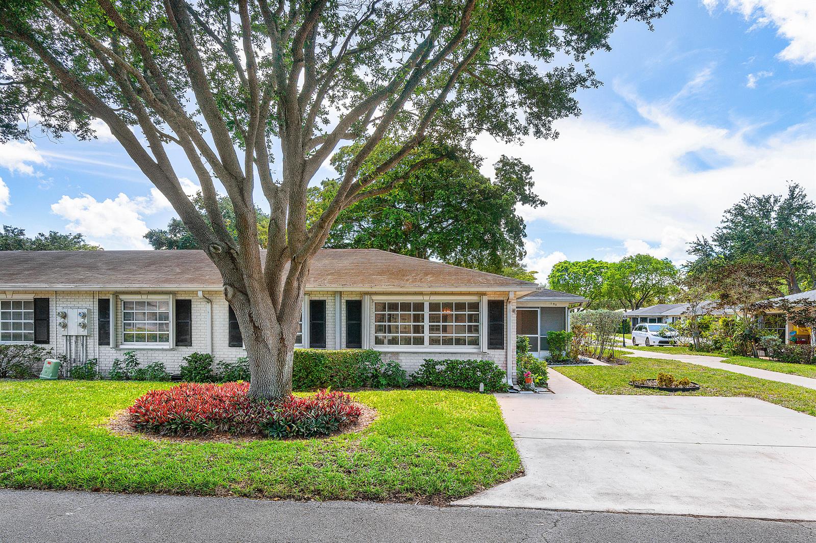 A single-story brick house features a large tree in the front yard and a driveway — 10141 S 41st Dr Drive # 193, Boynton Beach FL 33436, BOYNTON BEACH, FL