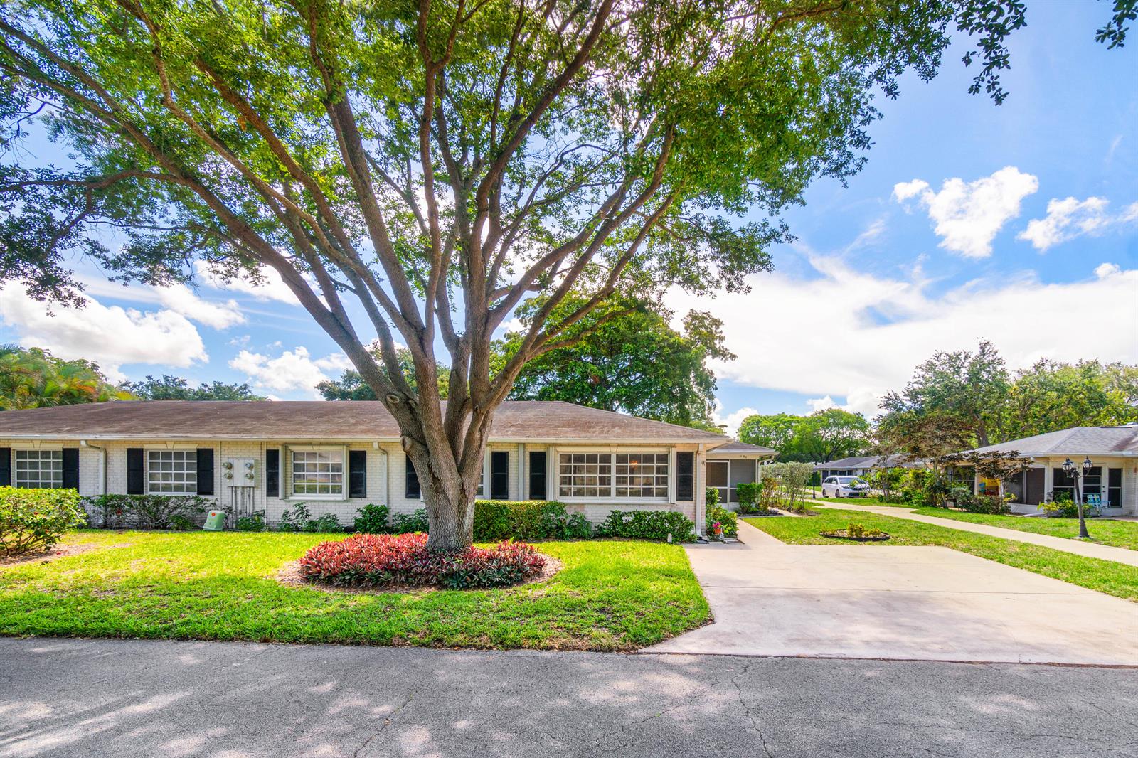 A single-story white brick building with a large tree in the front yard — 10141 S 41st Dr Drive # 193, Boynton Beach FL 33436, BOYNTON BEACH, FL