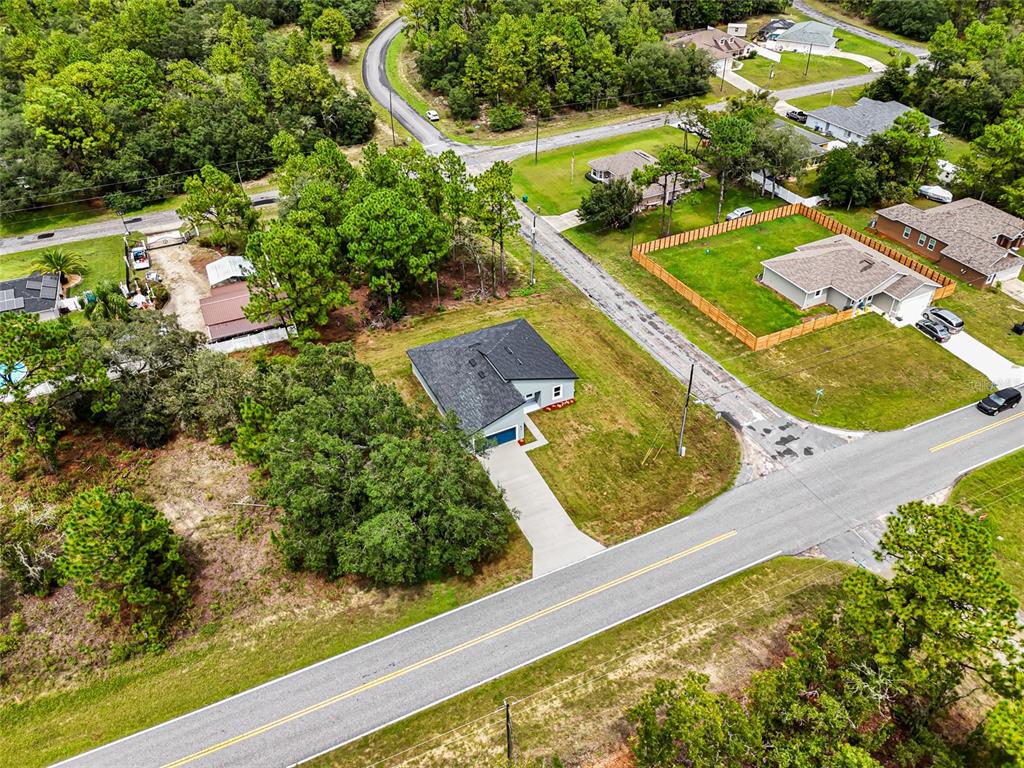 A modern kitchen features white cabinets, stainless steel appliances, a center island, and light flooring — 1071 W HAMPSHIRE BOULEVARD, DUNNELLON, FL