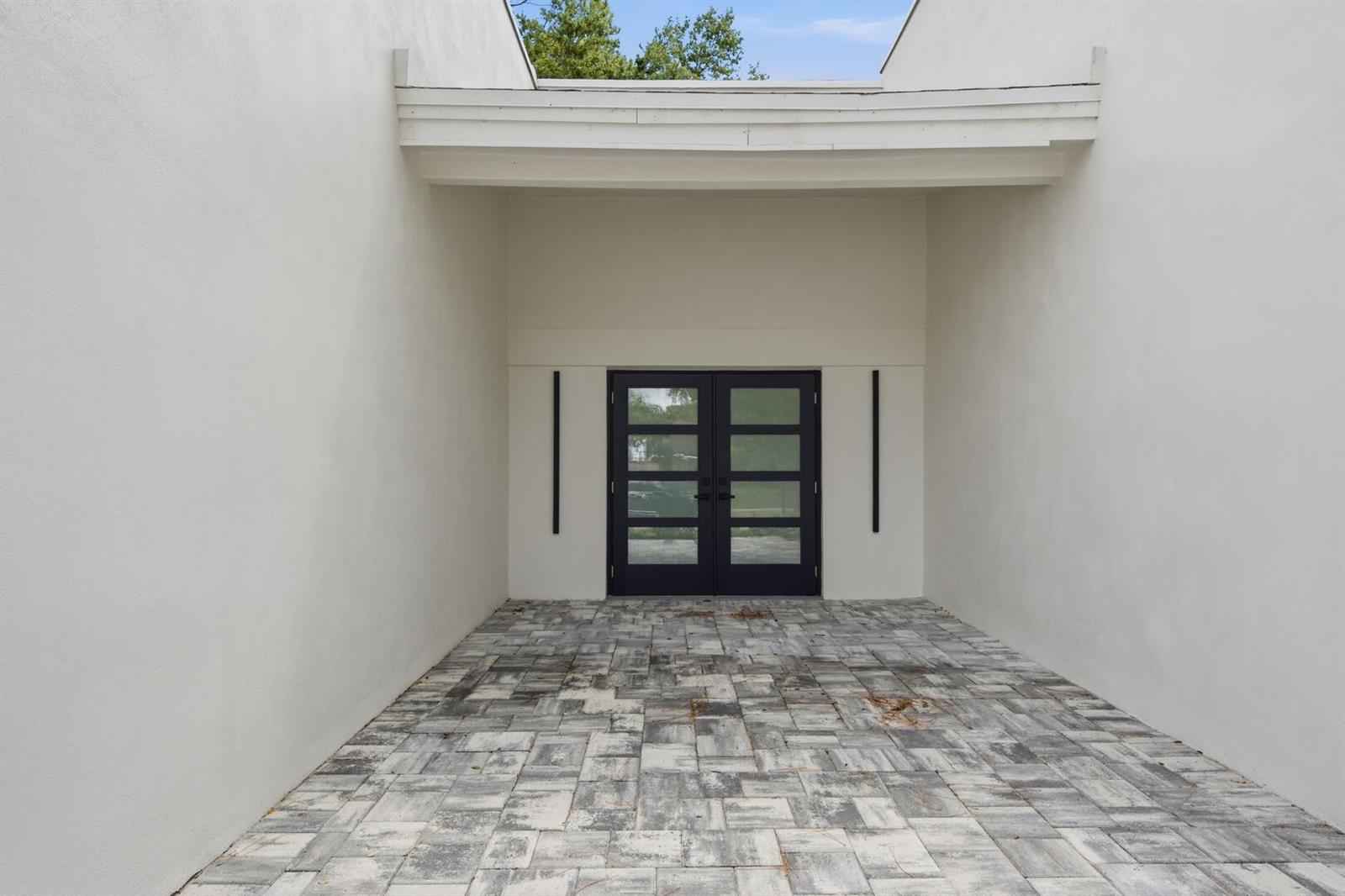 A paved entryway leads to a set of black double doors flanked by vertical lights — 2908 NW 24th Way, Boca Raton FL 33431, BOCA RATON, FL