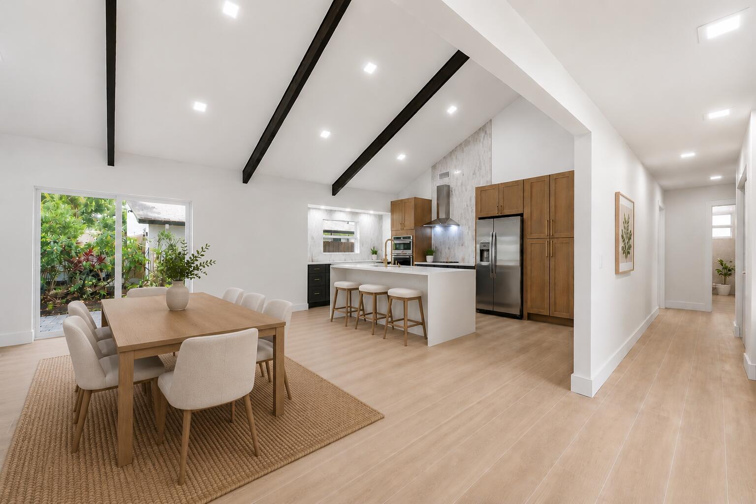 A modern open-concept kitchen and dining area features vaulted ceilings with dark wood beams — 2908 NW 24th Way, Boca Raton FL 33431, BOCA RATON, FL