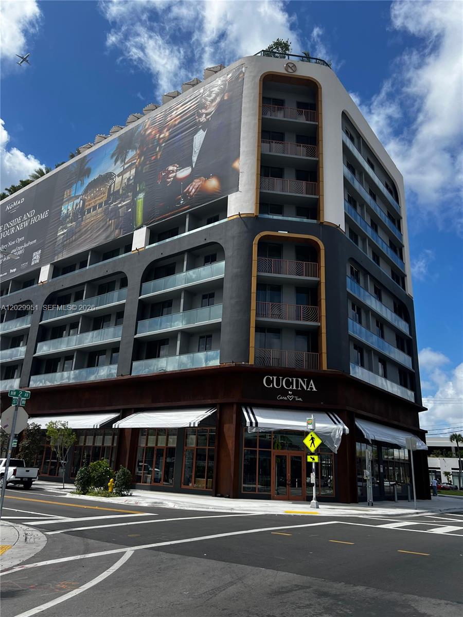 A multi-story building features a large advertisement mural, balconies, and a ground-floor restaurant — 2700 NW 2nd Ave # 544, Miami FL 33127, MIAMI, FL