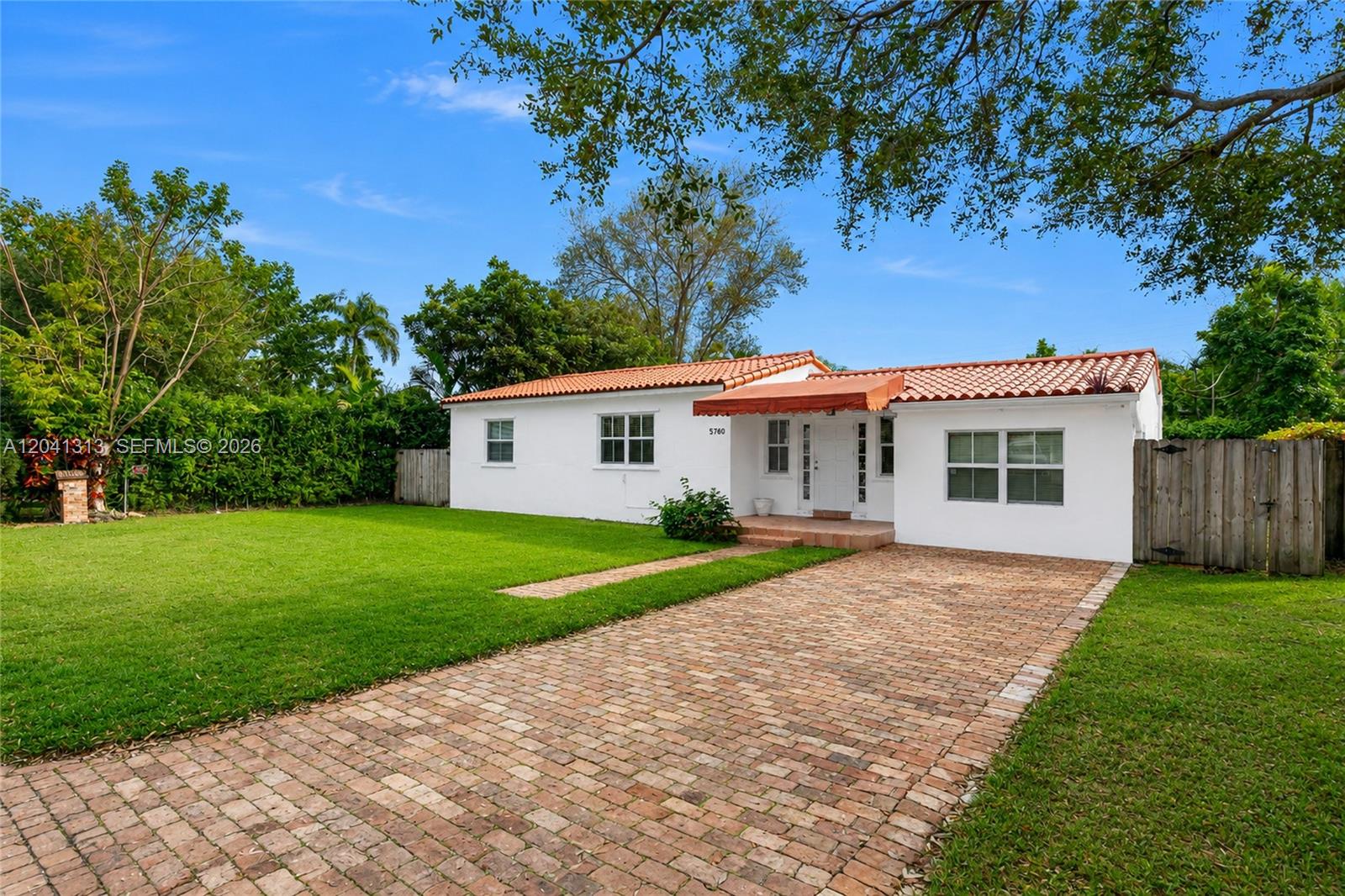 A white single-story house with a red tile roof and a brick driveway — 5760 SW 51st St # 0, Miami FL 33155, MIAMI, FL