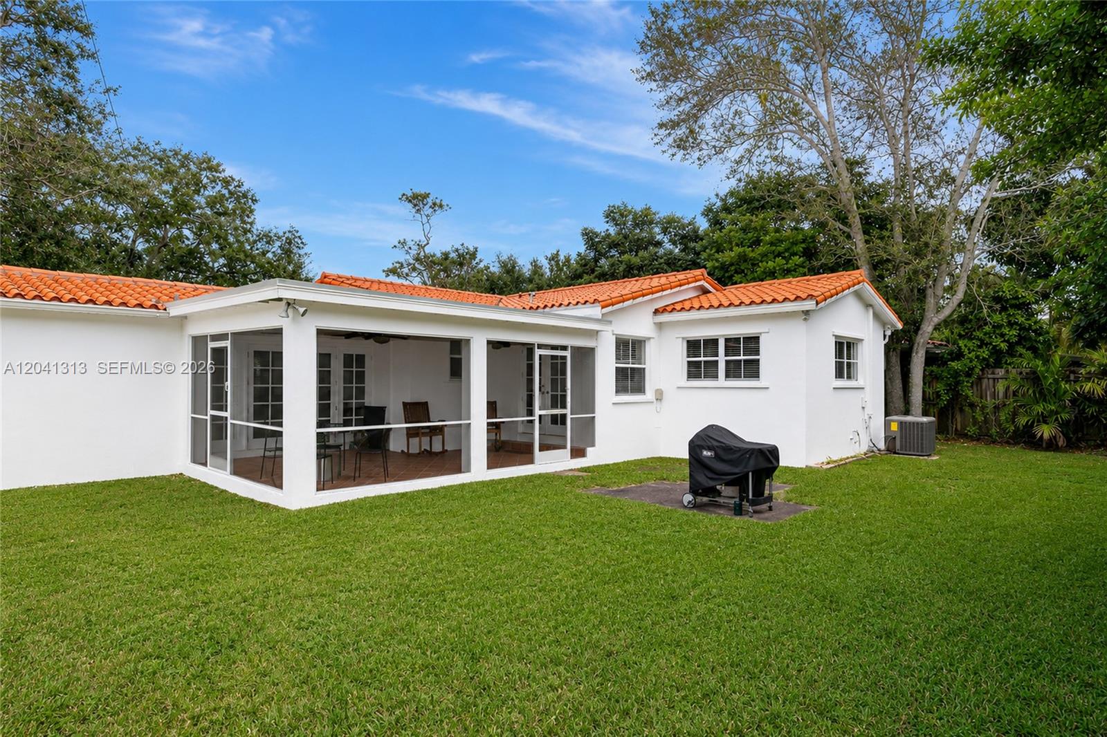 The exterior features a white house with a screened-in porch and an orange tile roof — 5760 SW 51st St # 0, Miami FL 33155, MIAMI, FL