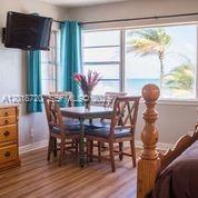 A bedroom with a dining table, chairs, and a window view of the ocean — N Surf Rd, Hollywood FL 33019, HOLLYWOOD, FL