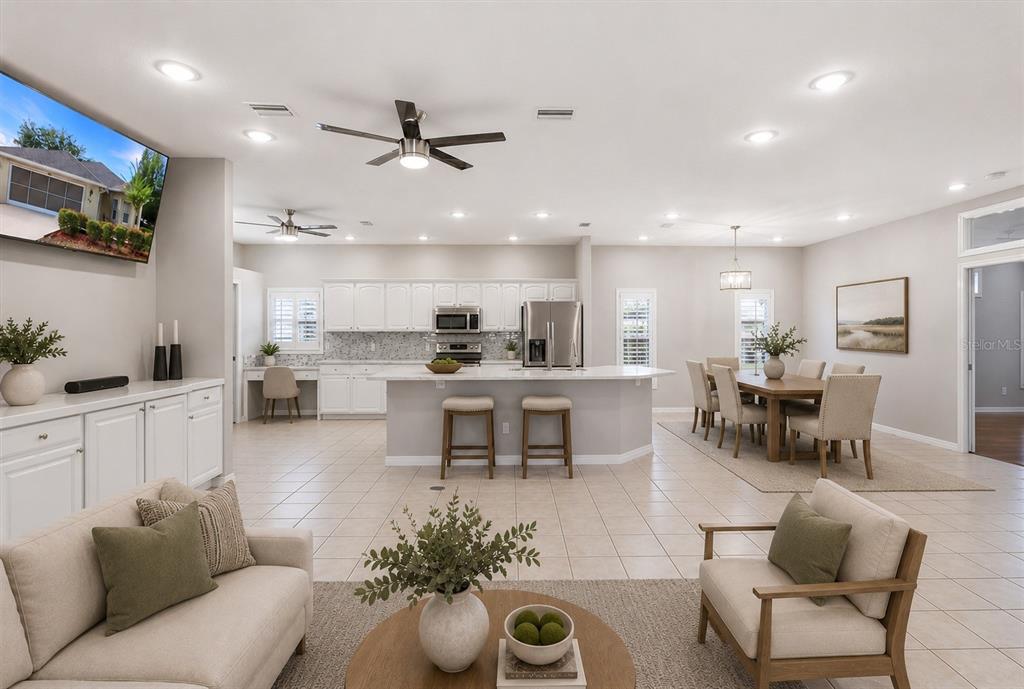 An open-concept living room and kitchen featuring white cabinetry, a central island, and tile flooring — 6484 W CANNONDALE DRIVE, CRYSTAL RIVER, FL