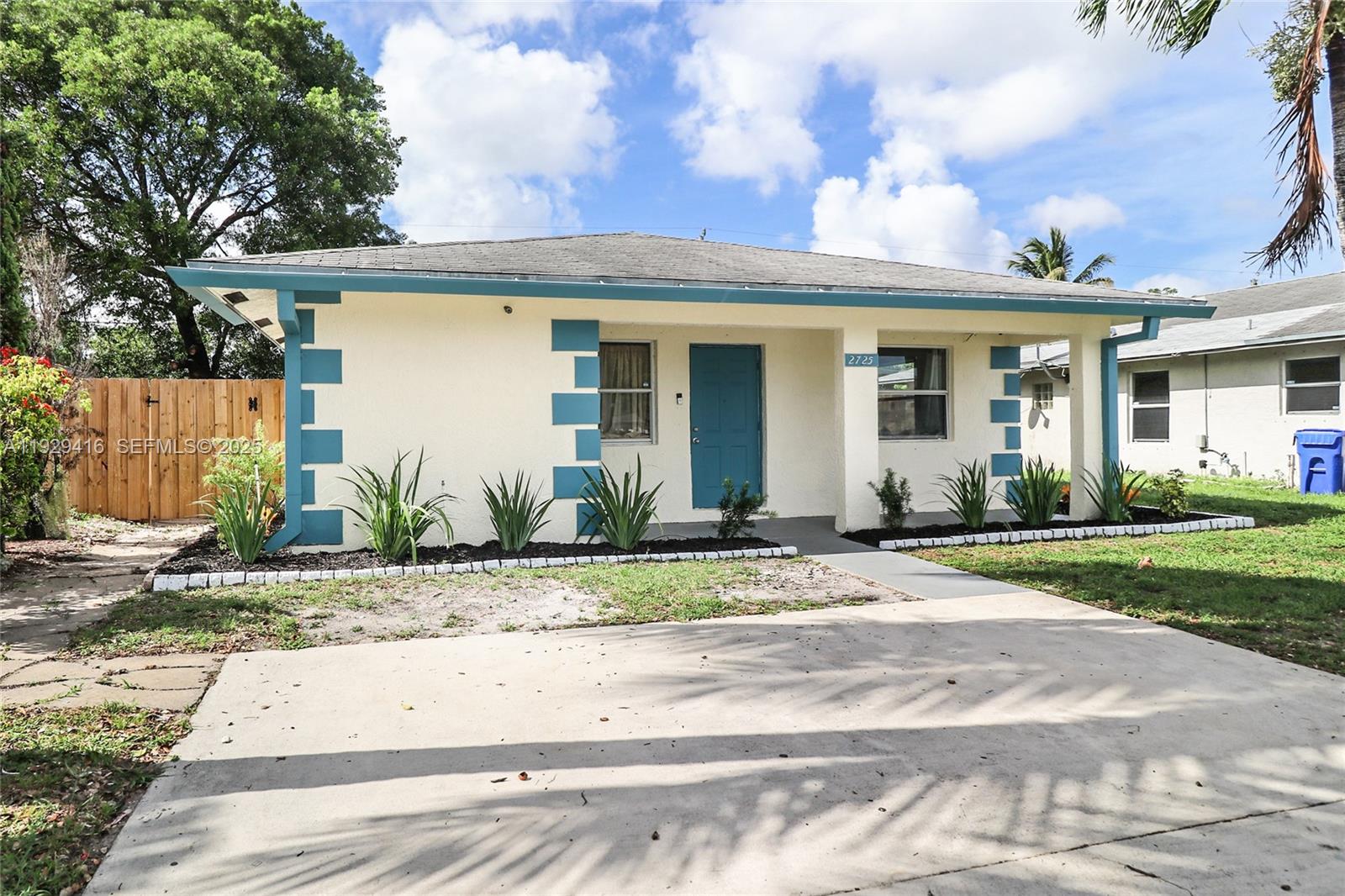 A single-story house with cream stucco walls, blue trim, and a concrete driveway — 2725 NW 3rd St, Pompano Beach FL 33069, POMPANO BEACH, FL