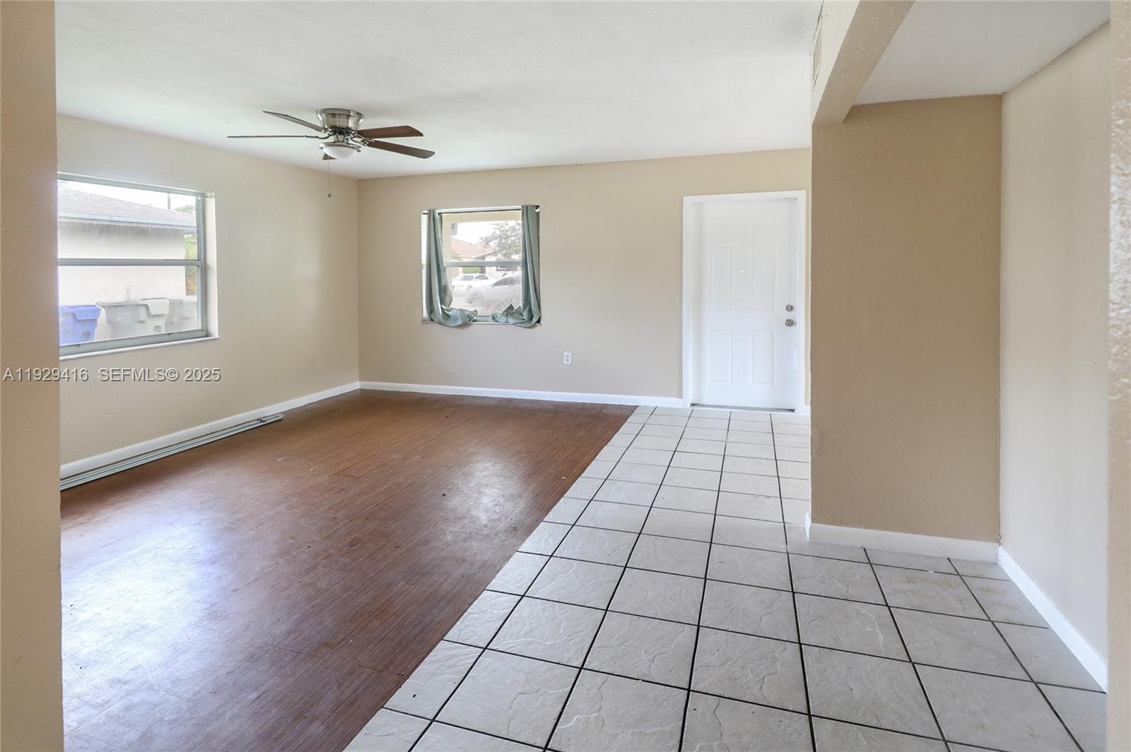 This living area features a mix of wood-look flooring and white square floor tiles — 2725 NW 3rd St, Pompano Beach FL 33069, POMPANO BEACH, FL