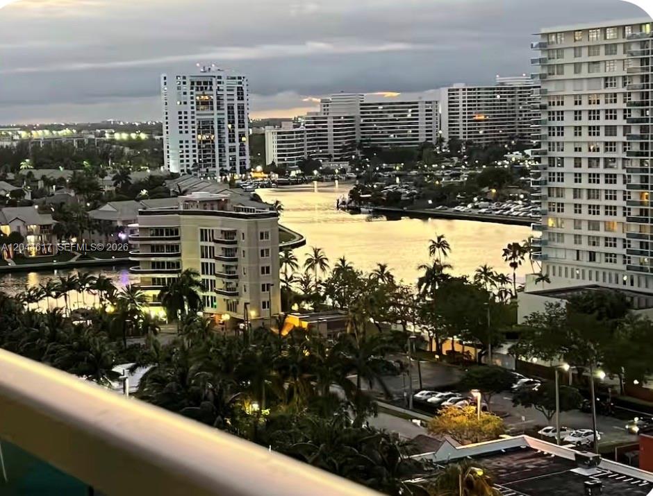 An elevated view of a waterway surrounded by high-rise apartment buildings and palm trees — 4001 S Ocean Dr # 14H, Hollywood FL 33019, HOLLYWOOD, FL