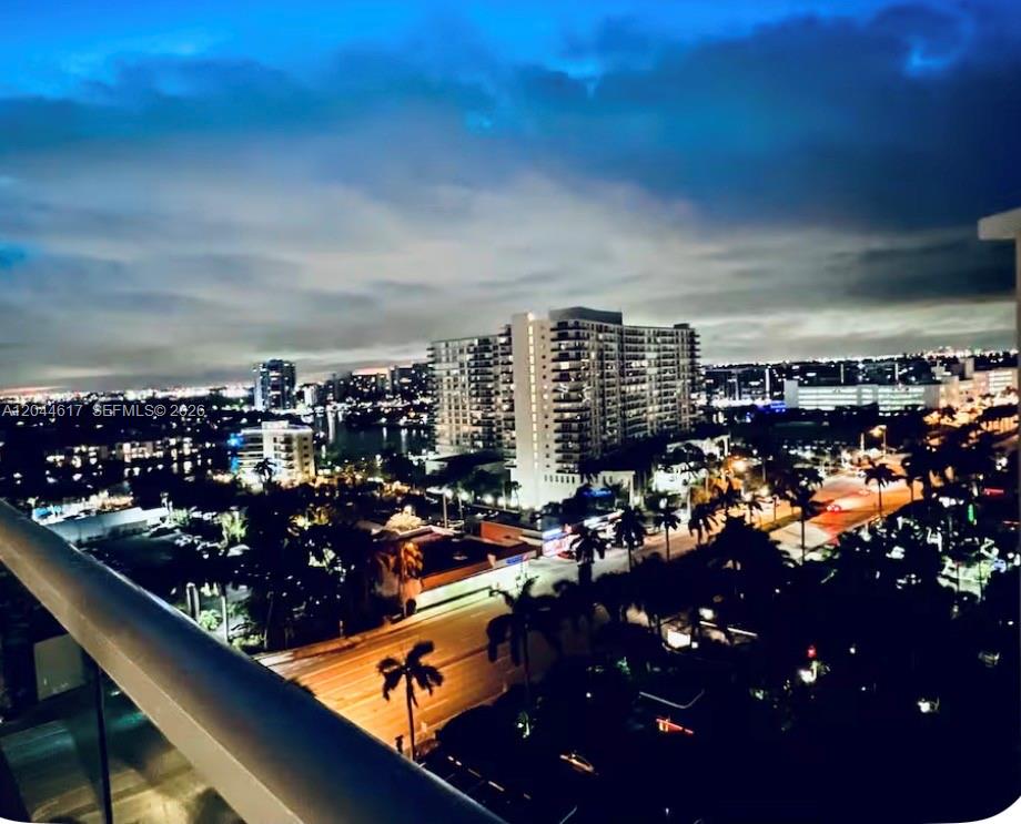 An elevated night view of a city skyline with buildings, palm trees, and illuminated streets — 4001 S Ocean Dr # 14H, Hollywood FL 33019, HOLLYWOOD, FL