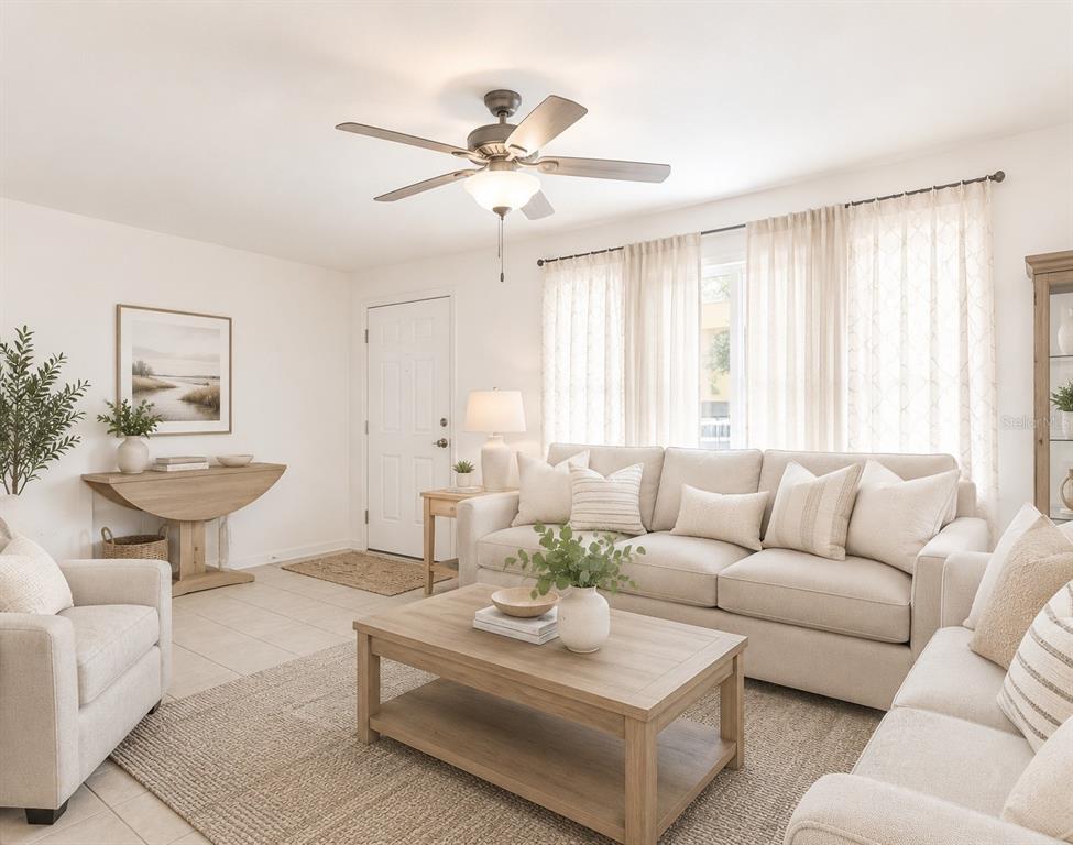 A living room features a beige sofa, matching armchair, wooden coffee table, and ceiling fan — 7115 LEXINGTON CIRCLE, BROOKSVILLE, FL