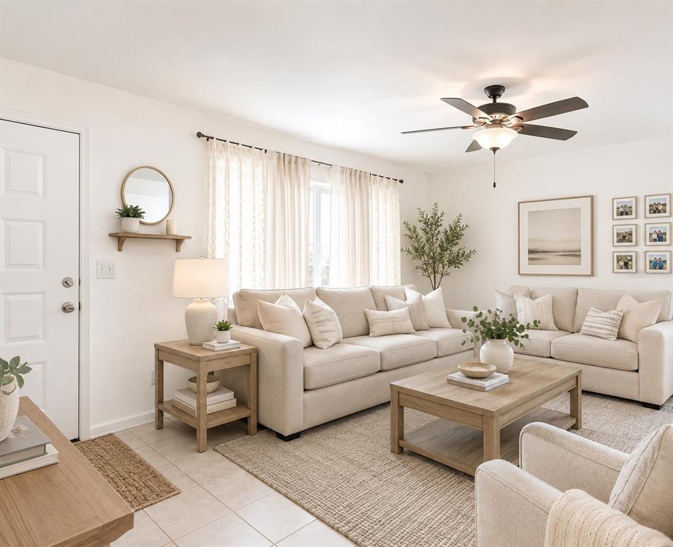 A bright living room features beige sofas, a wooden coffee table, and a ceiling fan — 7115 LEXINGTON CIRCLE, BROOKSVILLE, FL