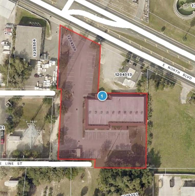 This aerial map shows a commercial property with a building and parking lot — 401 E NORTH BOULEVARD UNIT 101, LEESBURG, FL