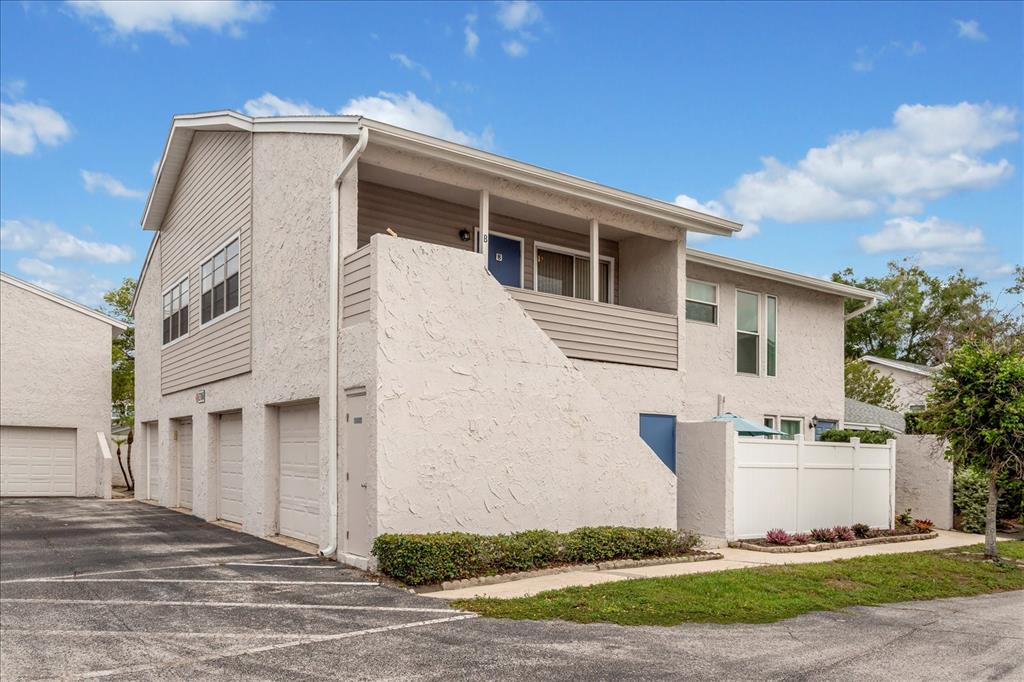 A two-story residential building with a stucco exterior, garage bays, and an upper-level balcony — 2786 CURRY FORD ROAD UNIT 6B, ORLANDO, FL