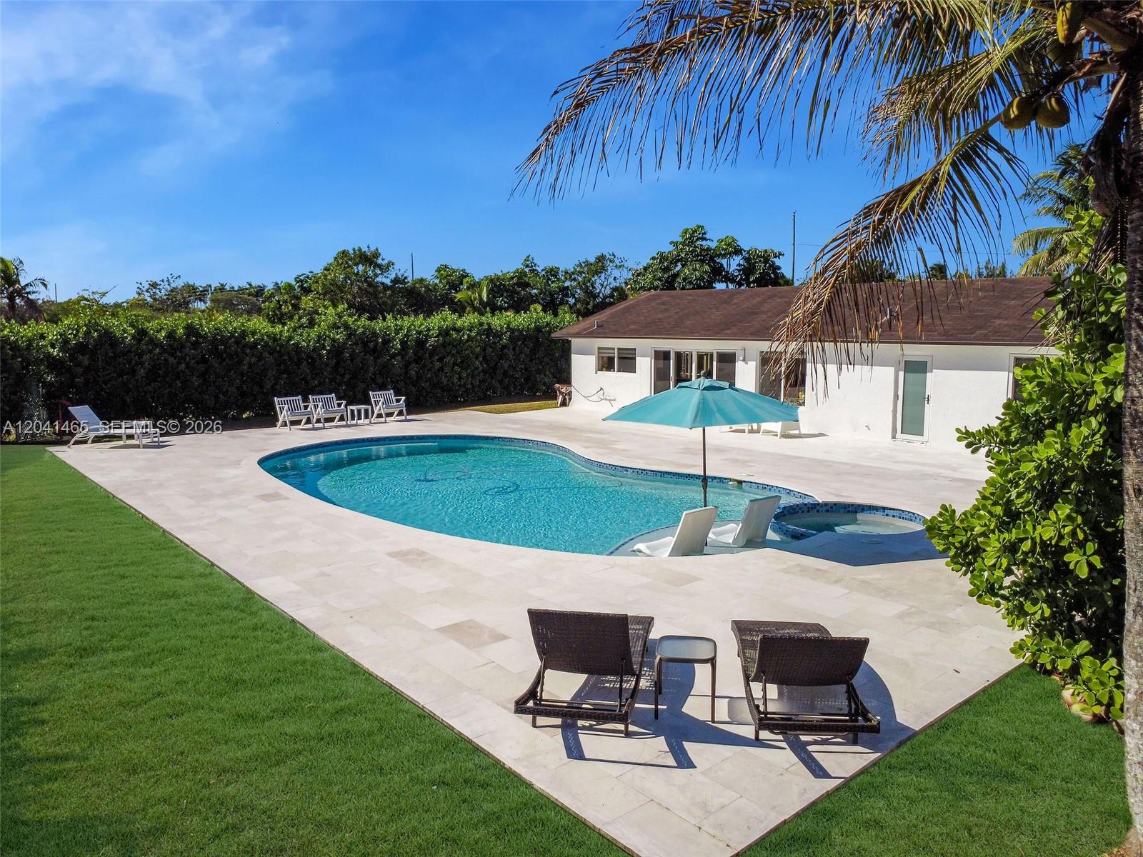 A backyard features a swimming pool with a spa, patio furniture, and a white house — 13201 SW 197th Ave, Miami FL 33196, MIAMI, FL