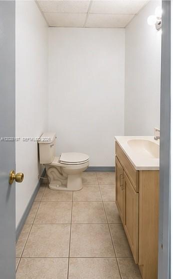 A bathroom with beige floor tiles, a light wood vanity, and a white toilet — 5555 NW 74th Ave # 5555, Miami FL 33166, MIAMI, FL