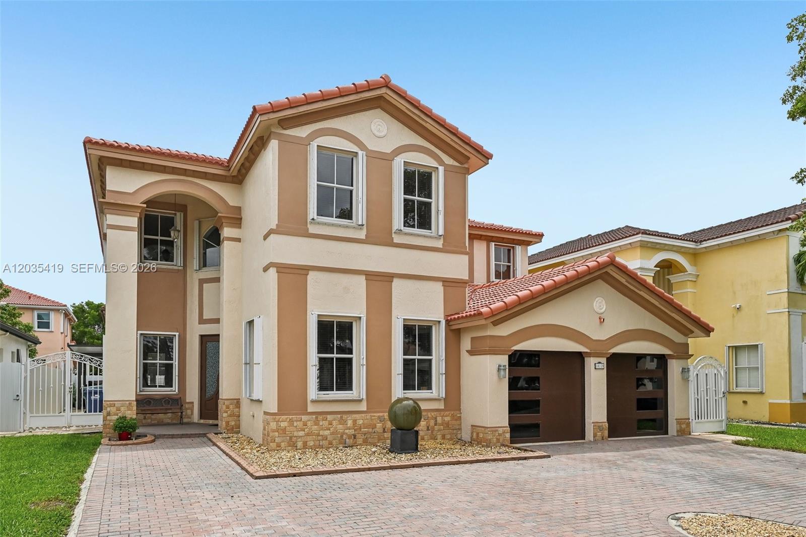 A two-story house with a tiled roof, stucco exterior, and a two-car garage — 18159 NW 90th Ave, Hialeah FL 33018, HIALEAH, FL