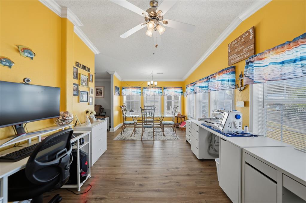 A bright yellow room features a dining area, a computer desk, and a sewing station — 10100 BURNT STORE ROAD UNIT 63, PUNTA GORDA, FL
