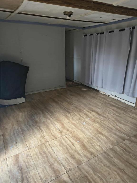 An interior room features light-colored tile flooring, gray walls, and light gray curtains — 2840 EATON AVENUE, LAKELAND, FL
