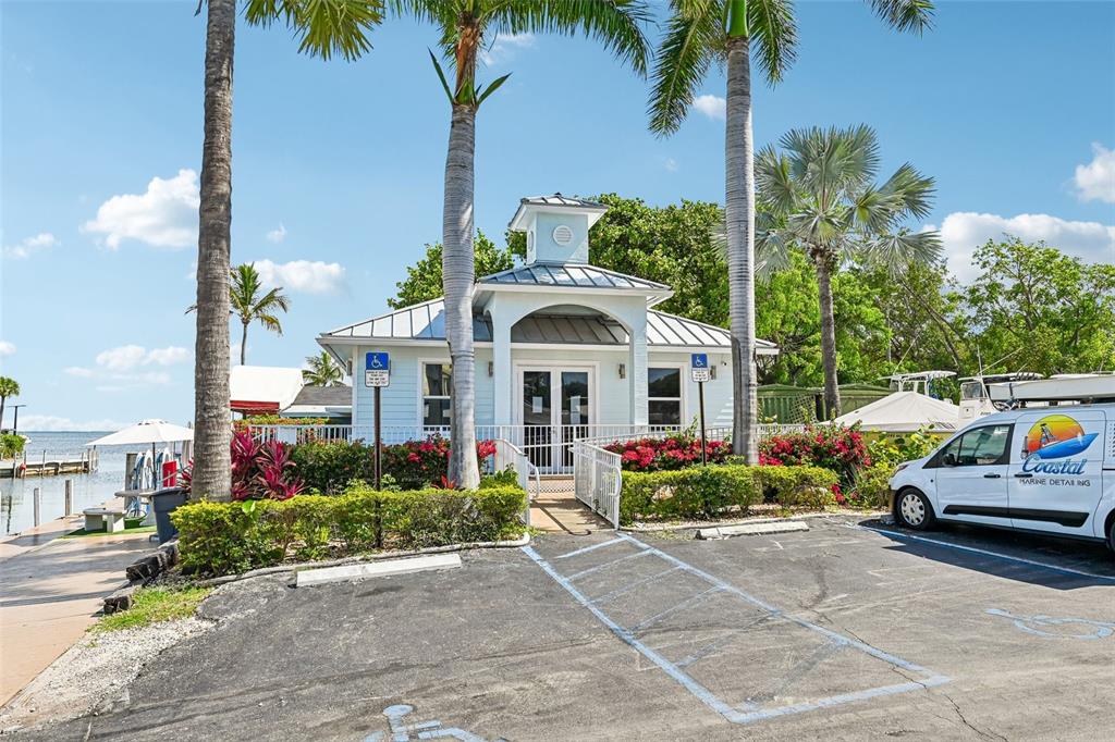 A light blue building with a cupola stands near a parking lot and water — 103950 OVERSEAS HIGHWAY UNIT RU62, KEY LARGO, FL