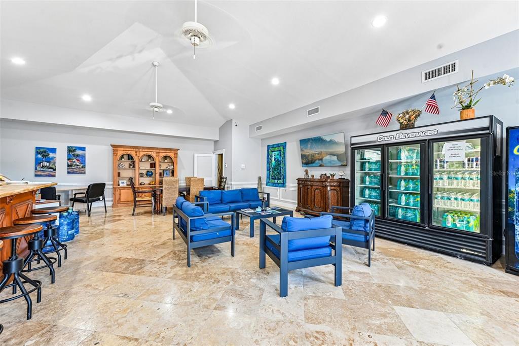 A spacious room features tile floors, blue seating, a bar area, and a beverage cooler — 103950 OVERSEAS HIGHWAY UNIT RU62, KEY LARGO, FL